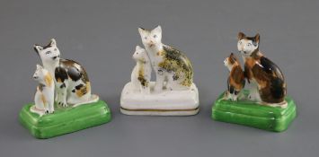 Three Staffordshire porcelain groups of a cat and kitten, c.1835-50, each with tortoiseshell