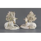 A pair of Derby gilt and white porcelain figures of deer, c.1810-30, each recumbent before bocage,