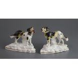 A pair of Staffordshire porcelain figures of Newfoundlands, c.1835-50, on rocky bases, L. 11.