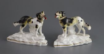 A pair of Staffordshire porcelain figures of Newfoundlands, c.1835-50, on rocky bases, L. 11.