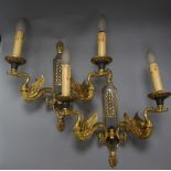 A pair of Empire-style cut metal twin branch wall lights