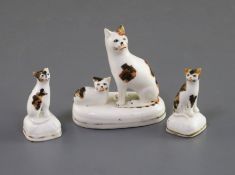 A Staffordshire porcelain group of a seated cat and kitten and two similar figures of kittens, c.