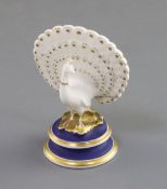 A Chamberlain Worcester porcelain figure of a peacock, c.1820-40, on a circular dry blue and gilt