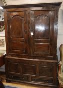 A mid 18th century walnut press cupboard, with two panelled doors and two base drawers, on stile