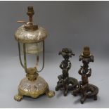 Two bronze putti candlesticks converted to lamps and a glass lamp