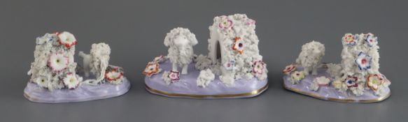 Three Staffordshire porcelain figures of a poodle and kennel, c.1835-45, with textured fur and