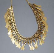 A yellow metal fringe necklace of openwork design hung with tulip-shaped drops (tests as 18ct),