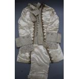 A 19th century cream and gold page boys suit with diamonte buttons, gold thread edging and lace