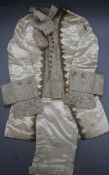 A 19th century cream and gold page boys suit with diamonte buttons, gold thread edging and lace