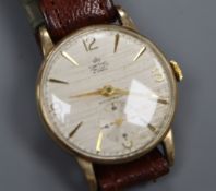 A gentleman's Smiths 9ct gold wristwatch with textured satin Arabic dial and subsidiary seconds.