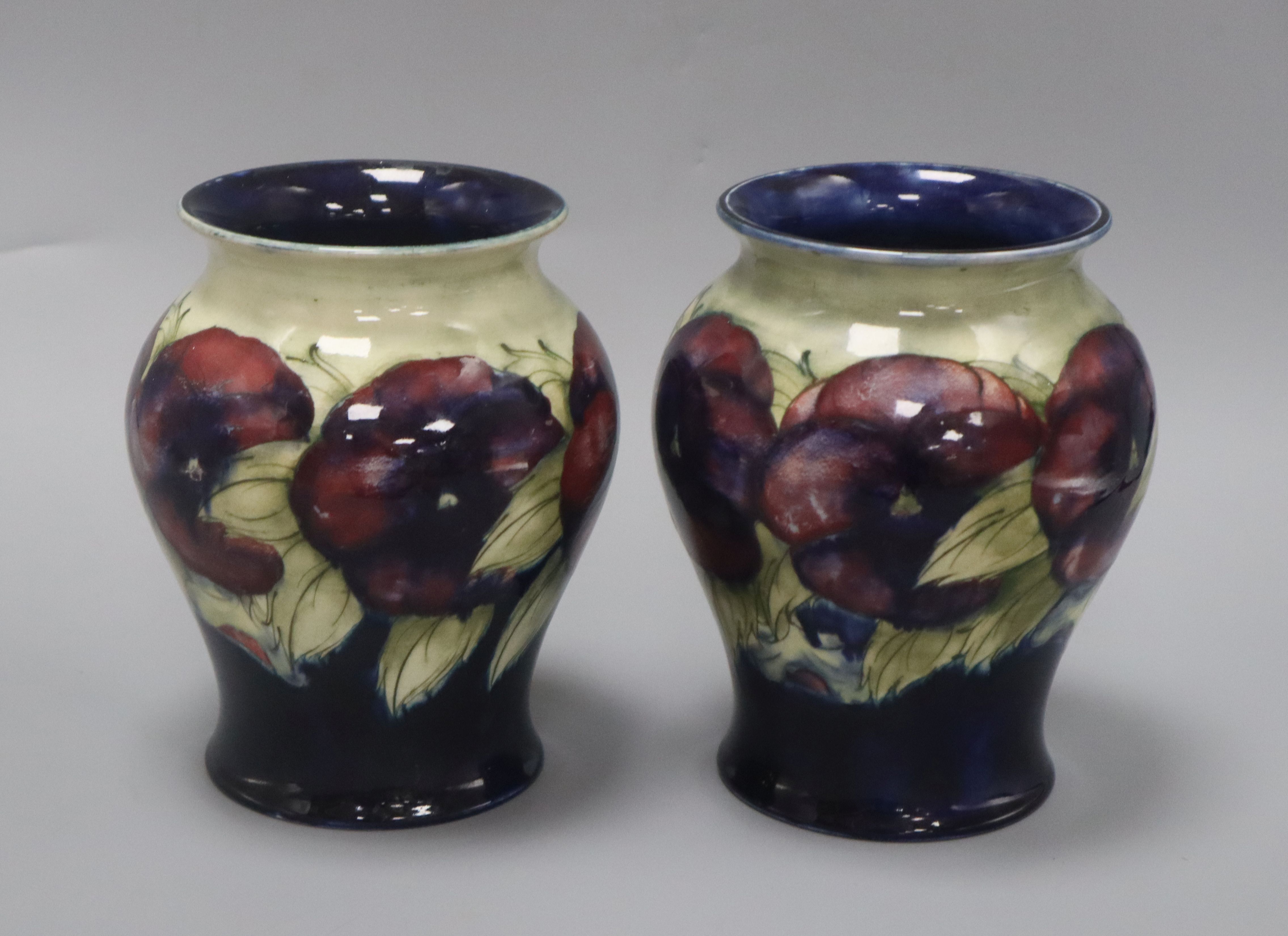 A pair of Moorcroft Pansy vases height 17cm