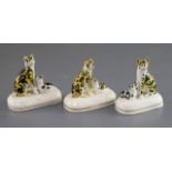 Three Staffordshire porcelain groups of a cat and kitten, c.1830-50, each feline with