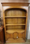 A reproduction French walnut tall bookcase W.120cm