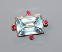 A 15ct, synthetic? ruby and aquamarine set brooch, 25mm.