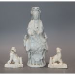 A Chinese blanc de chine figure of Guanyin and a pair of lion dog joss-stick holders, faults and a