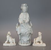 A Chinese blanc de chine figure of Guanyin and a pair of lion dog joss-stick holders, faults and a