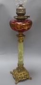 An ormolu and onyx oil lamp with cranberry reservoir