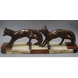 A French Art Deco bronzed metal group of two foxes, on hardstone base length 60cm