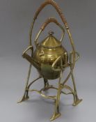 An Art Nouveau brass spirit kettle