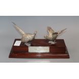A modern silver presentation trophy modelled as two pheasants mounted on a wooden plinth, London,