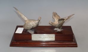 A modern silver presentation trophy modelled as two pheasants mounted on a wooden plinth, London,