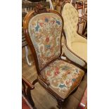A Victorian walnut spoon back nursing chair with tapestry upholstery