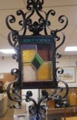A wrought iron stained glass hall lantern