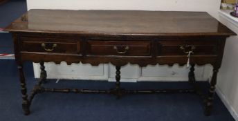 A James II oak dresser, the moulded projecting top over three drawers with fielded fronts above