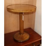 A quarter-veneered mahogany occasional table on cylindrical column and circular lead-weighted foot