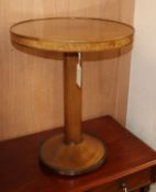 A quarter-veneered mahogany occasional table on cylindrical column and circular lead-weighted foot