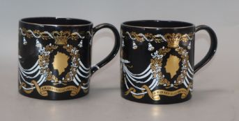 A pair of Wedgwood commemorative ware mugs and a Paragon china mug