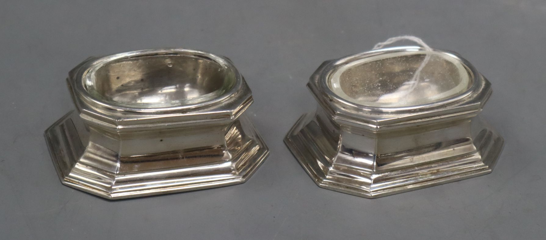 A pair of Brittania standard silver trencher salts with glass liners, Tessiers Ltd, London, 1957,
