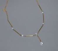 A modern 18ct gold and aquamarine set drop necklace, 47cm.