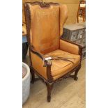 A 19th century French carved oak and tan leather reclining armchair
