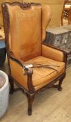 A 19th century French carved oak and tan leather reclining armchair