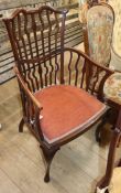 An Edwardian mahogany elbow chair