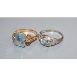 A 14k white metal and aquamarine ring and a 750 yellow metal and synthetic spinel? ring.