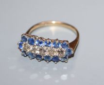 A 9ct gold, sapphire and diamond line cluster ring, size N/O.