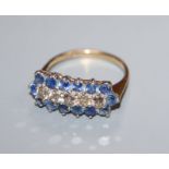 A 9ct gold, sapphire and diamond line cluster ring, size N/O.