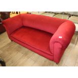 An Edwardian Chesterfield settee upholstered in red dralon W.180cm