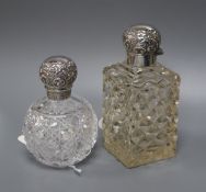 A silver-mounted cut glass toilet bottle and another similar bottle.