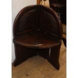 A small carved oak corner seat H.71cm