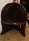 A small carved oak corner seat H.71cm