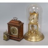 A gilt brass torsion clock under glass dome (a.f), an Elliot mantel clock and a miniature '