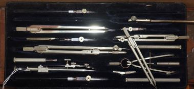 A cased set of drawing instruments by A G Thornton, four various cased slide rules and two