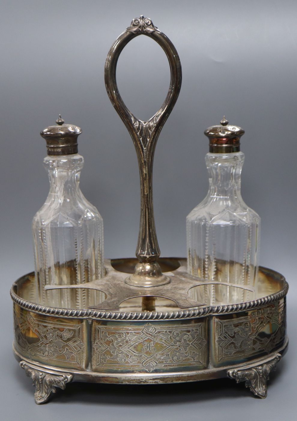 A Victorian silver oval cruet stand, Boardman & Glossup, Sheffield, 1875, with two associated silver