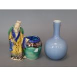 A Chinese blue glazed bottle vase, Kangxi mark but Republic period and a Chinese pottery figure