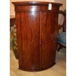 A George III mahogany bow front hanging corner cabinet H.100cm
