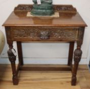 A small carved oak side table W.75cm