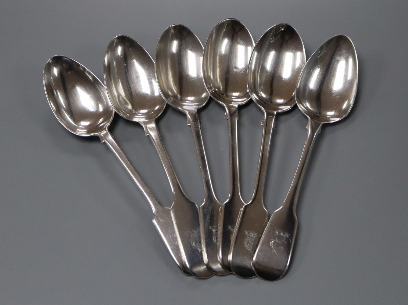 A matched set of six 19th century silver fiddle pattern dessert spoons including one by Paul